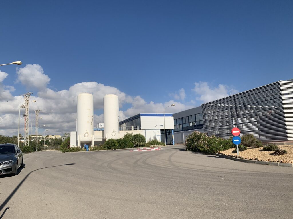 Large scale solar PV array located near a coastal industrial water treatment facility in Spain.