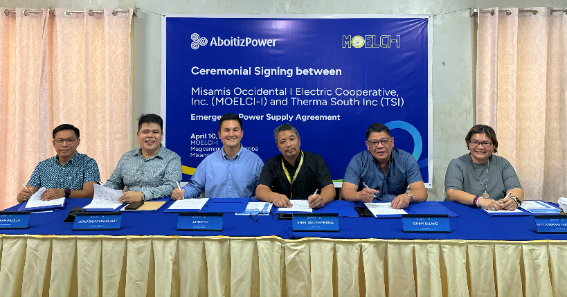 AboitizPower and MOELCI-I representatives signing an emergency power supply agreement in a formal boardroom setting.