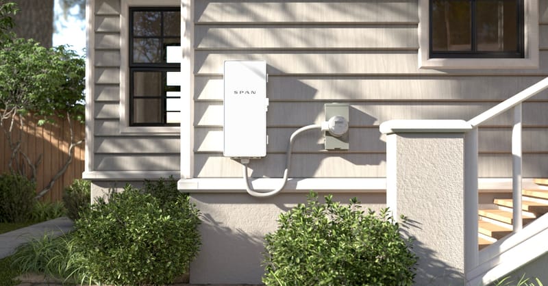A modern smart electrical panel mounted on a residential basement wall with connected wiring.