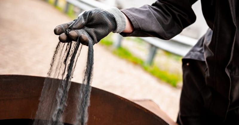 A glowing iron powder combustion process in a laboratory setting for industrial energy use.