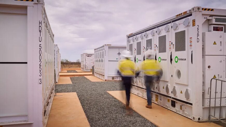 Large-scale battery energy storage system containers installed at a remote industrial solar site.