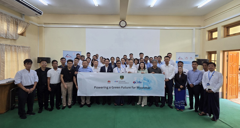 Huawei Digital Power representatives and Myanmar energy officials at a solar training facility for grid modernization.
