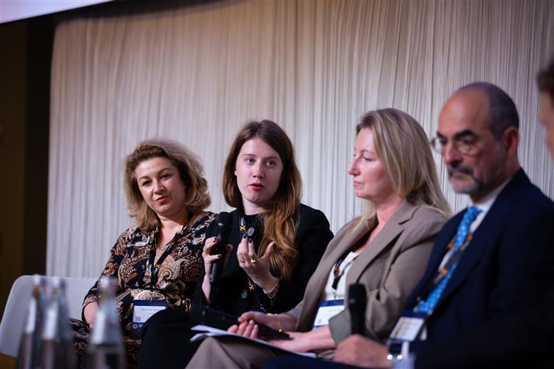 Container ships docked at a European port with solar panels waiting for inspection