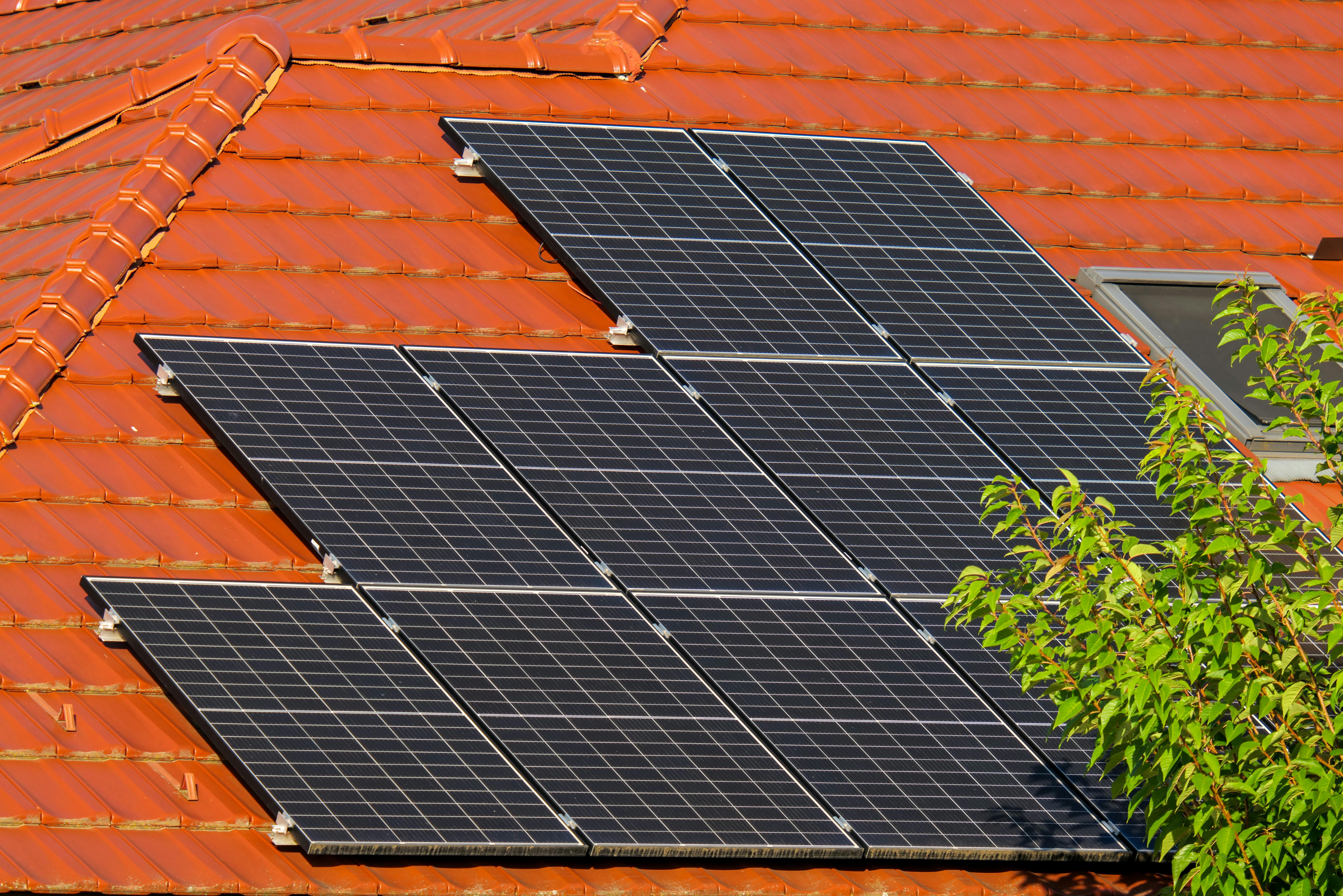 Workers installing residential solar panels on a rooftop in South Africa