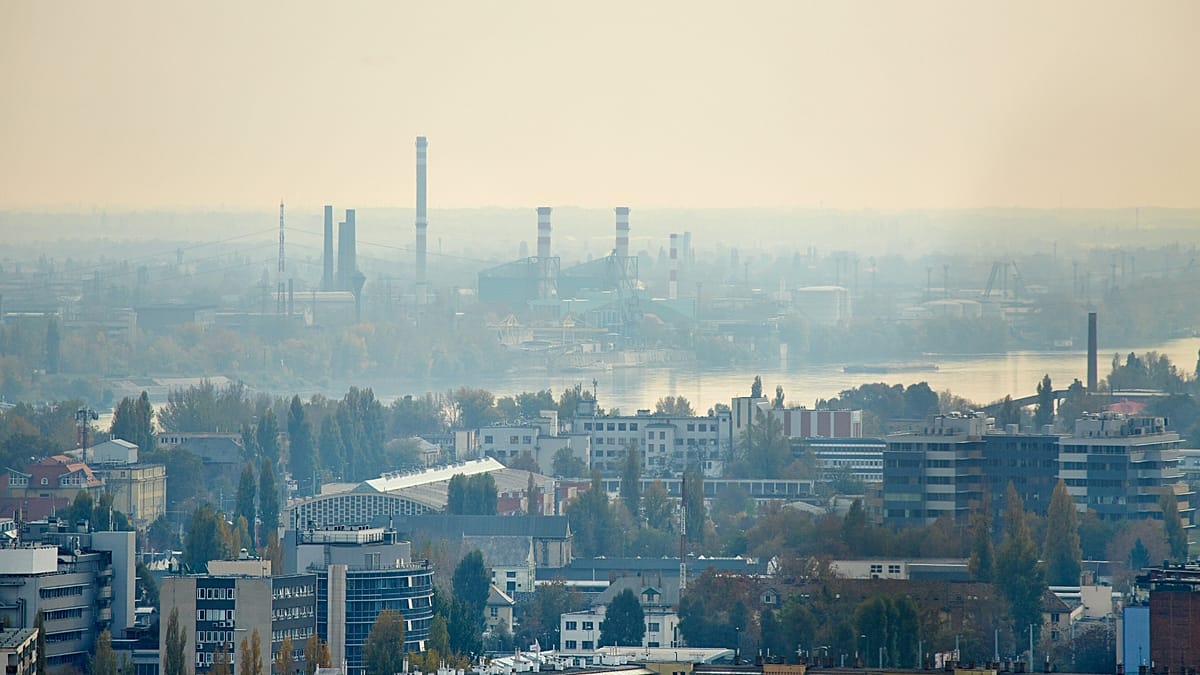 A technician installing high-efficiency solar panels on a European residential rooftop during sunset