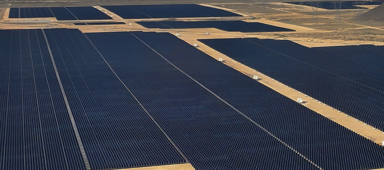 Large scale liquid cooled battery energy storage containers next to a solar farm