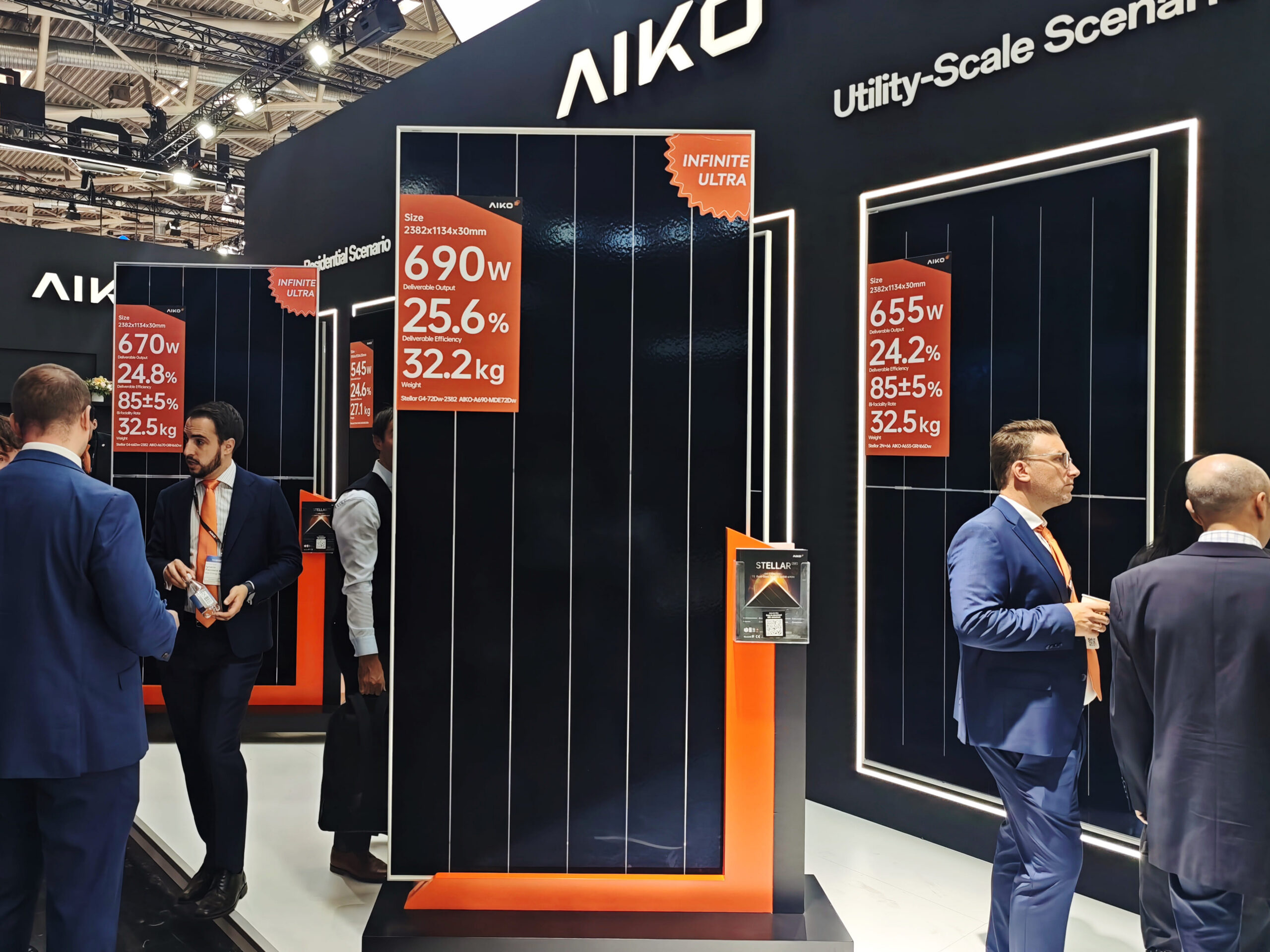 Aiko Solar 690W ABC module displayed at a trade show highlighting its sleek all-black back-contact design.