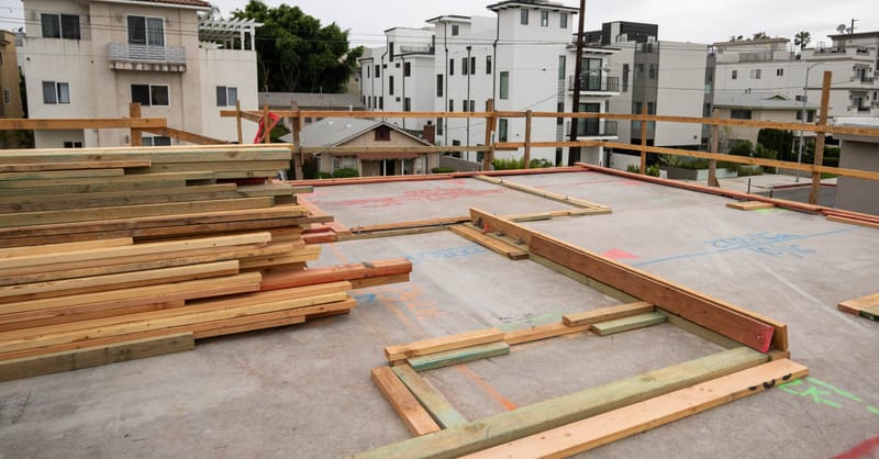 Electric vehicle charging station installed in a modern European residential apartment building parking garage.