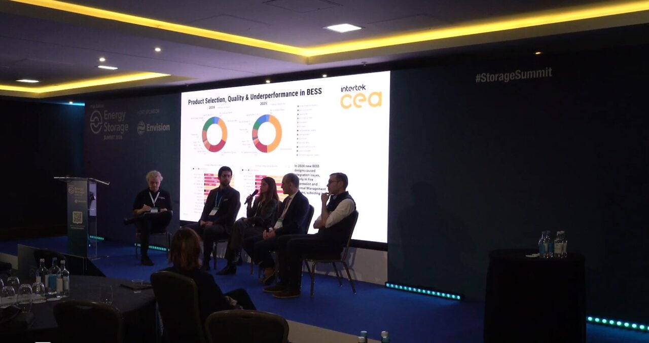 A technician inspecting a residential battery energy storage system (BESS) installation for quality control.