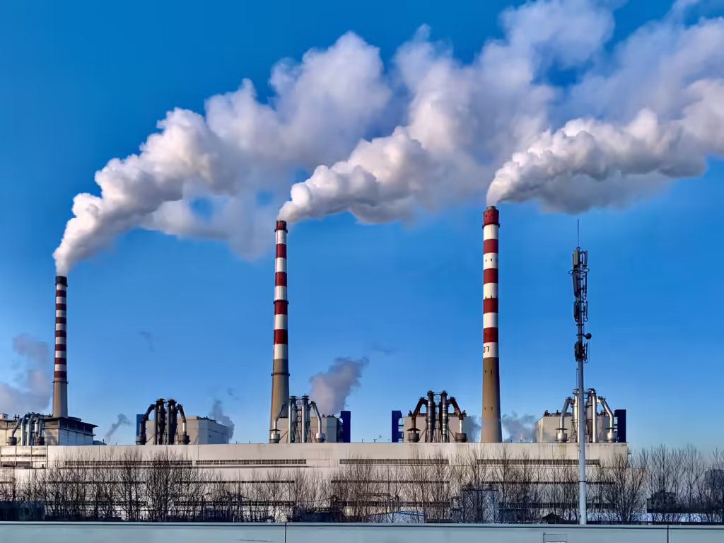 A Spanish wind turbine and solar farm under a blue sky in a mining region