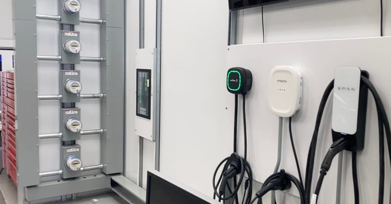 A modern smart home with solar panels, home battery storage, and an electric vehicle charging station.