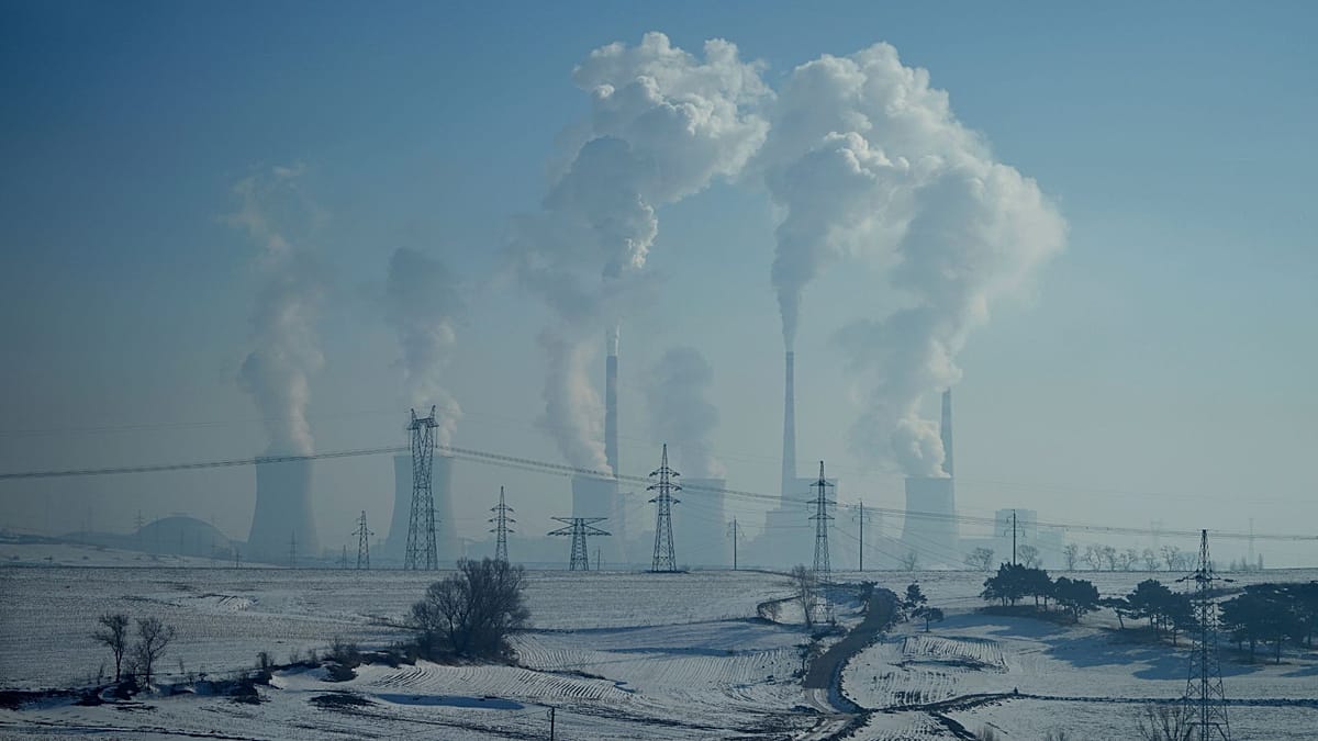 A modern solar farm located next to a coal-fired power plant in China.