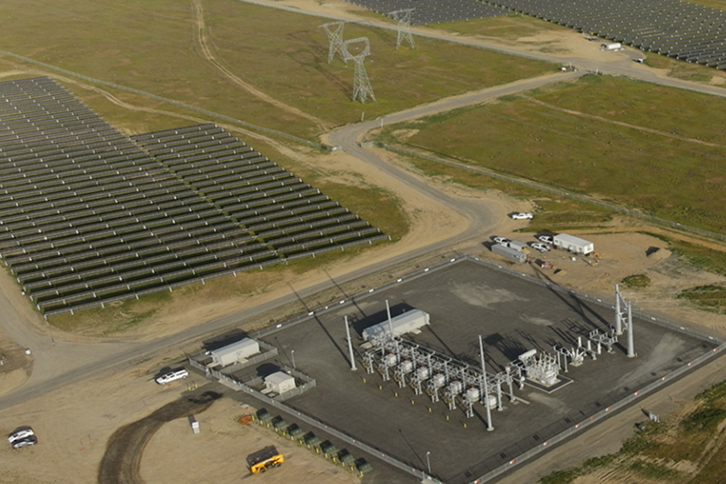 Large scale utility PV farm with rows of solar panels extending to the horizon