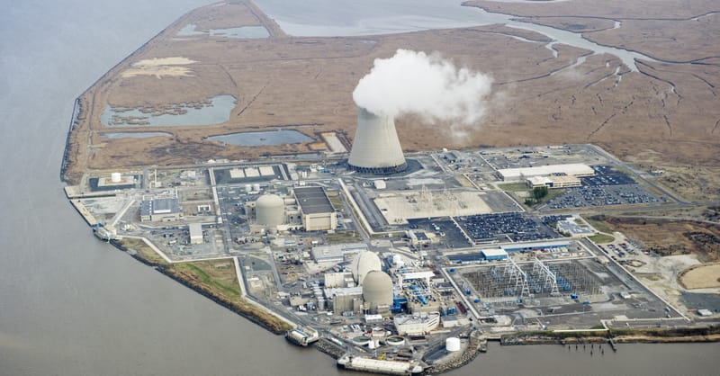 A modern solar panel installation mounted on a residential rooftop with a clear blue sky
